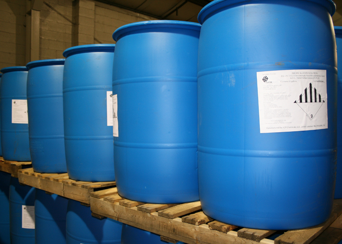 Nickel solution in blue drums sitting on wood pallets